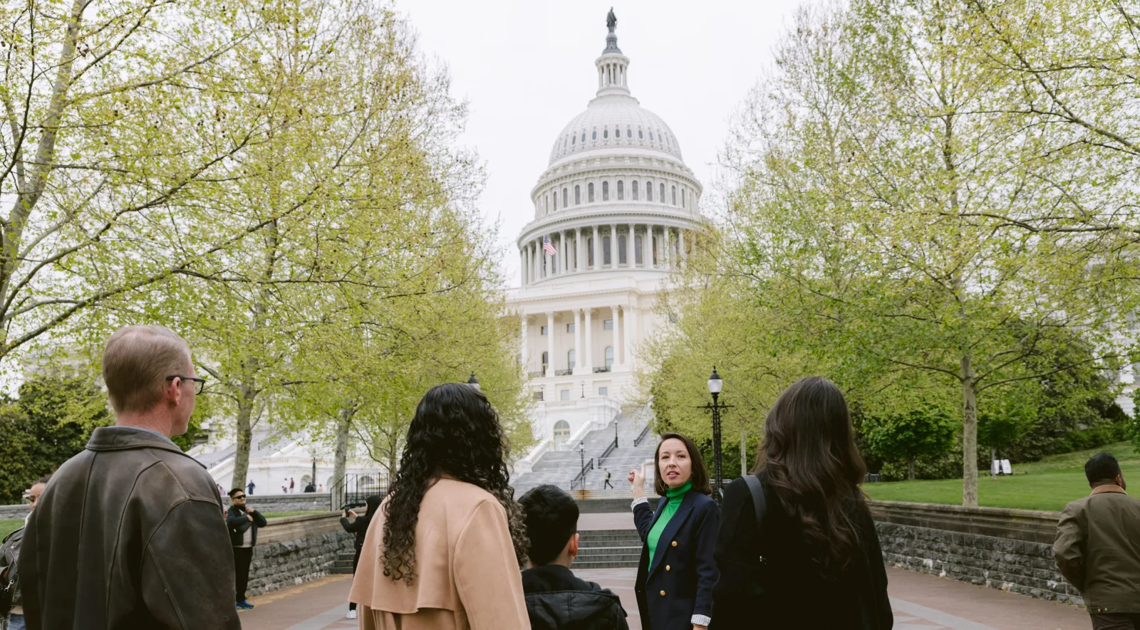 A guide leading a small group towards the Capitol