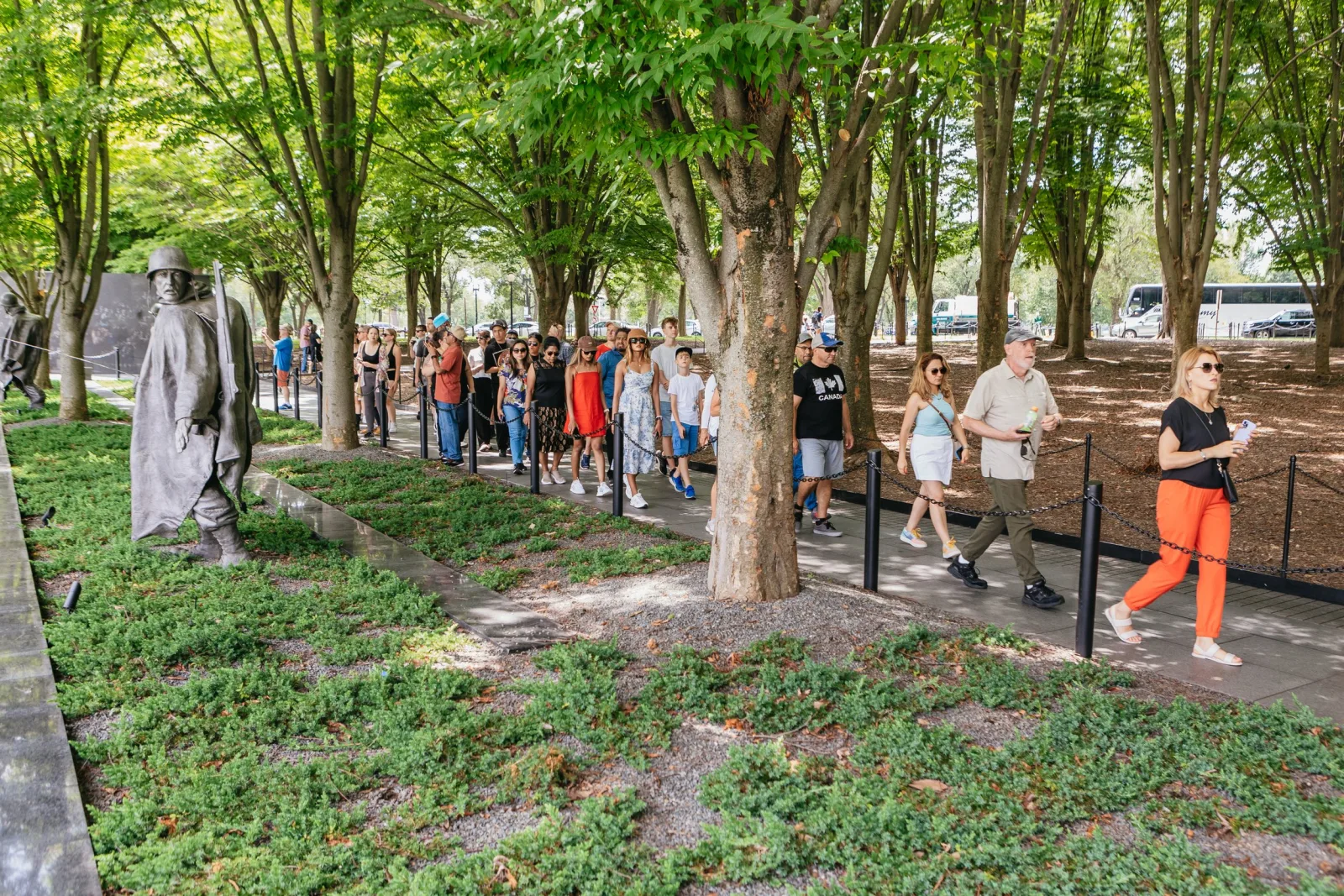 A guided group walking past the Vietnam Veterans Memorial